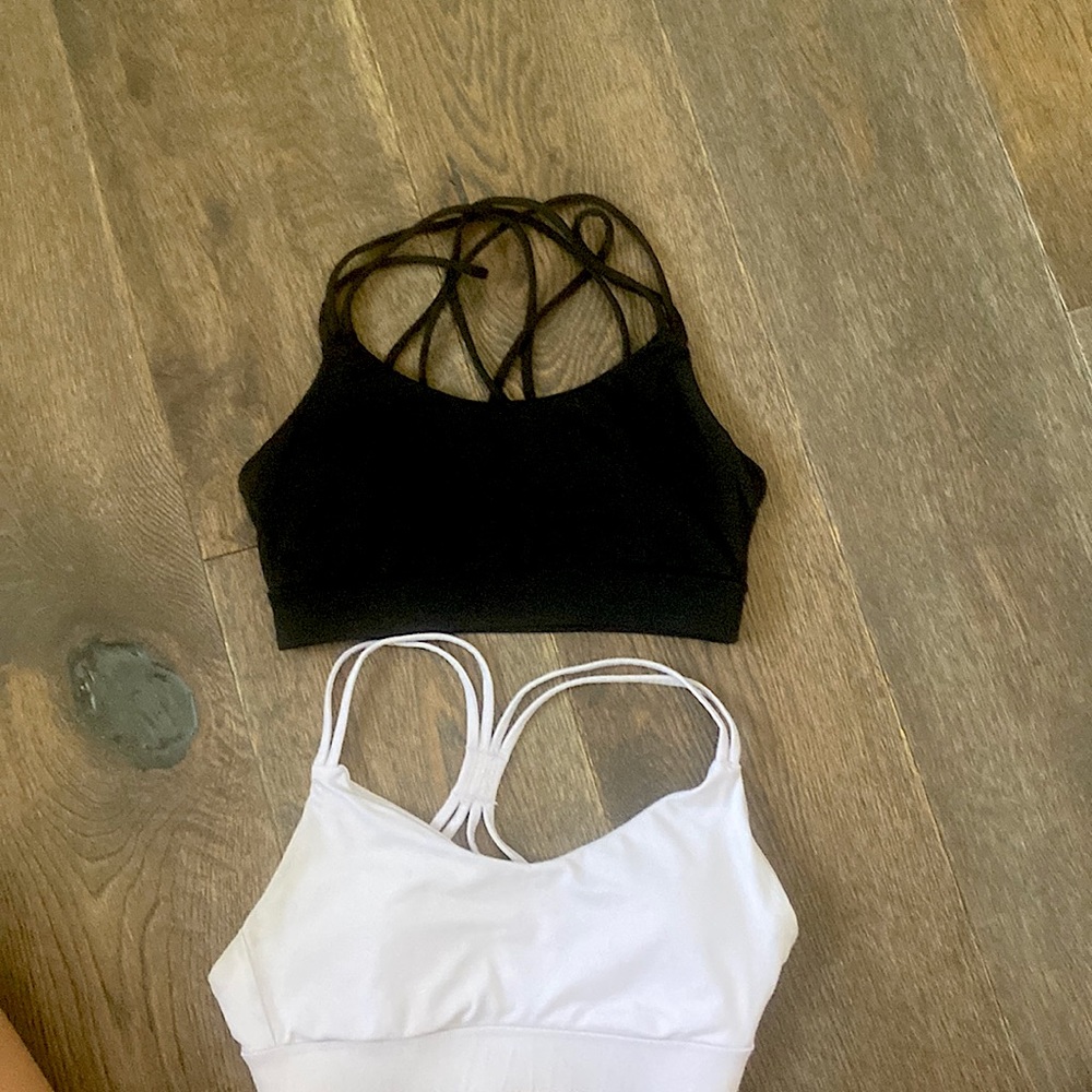 Two Forever 21 sports bras. Both XS one in black, one XS in light purple.